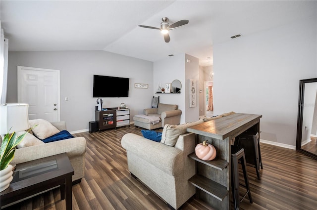 living room featuring dark hardwood / wood-style floors, vaulted ceiling, and ceiling fan