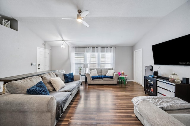 living room featuring vaulted ceiling, ceiling fan, a textured ceiling, and dark hardwood / wood-style flooring