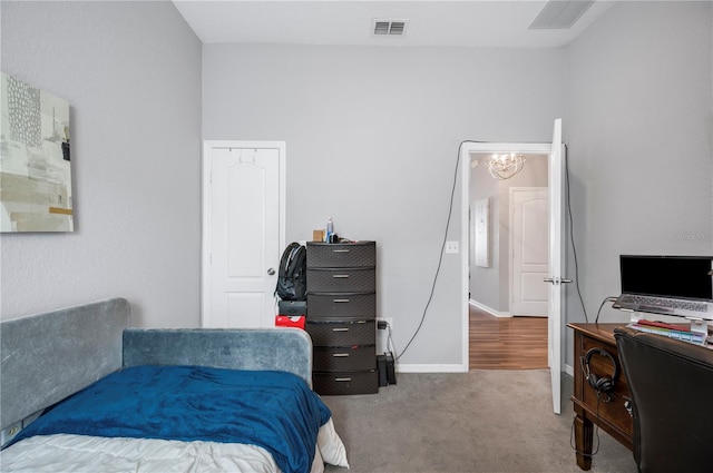 bedroom featuring carpet and a chandelier