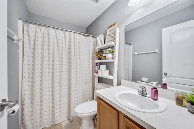 bathroom with a textured ceiling, toilet, vanity, a shower with shower curtain, and tile patterned flooring