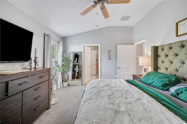 carpeted bedroom with vaulted ceiling and ceiling fan