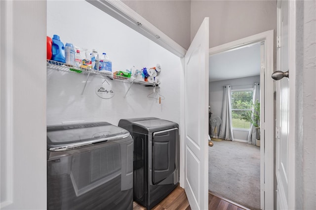 laundry room featuring wood-type flooring and washing machine and clothes dryer