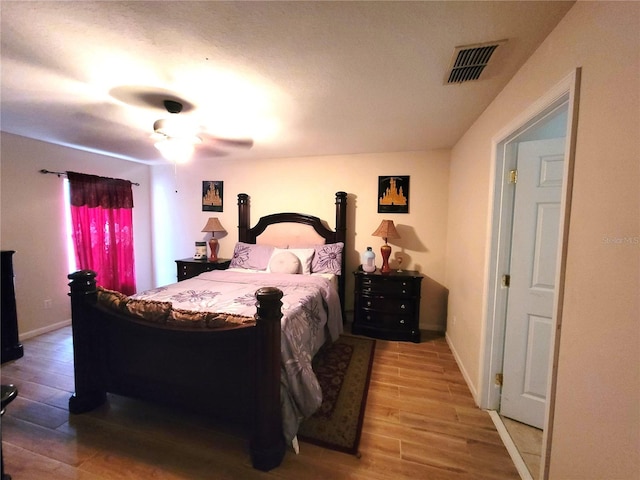 bedroom with light hardwood / wood-style floors and ceiling fan