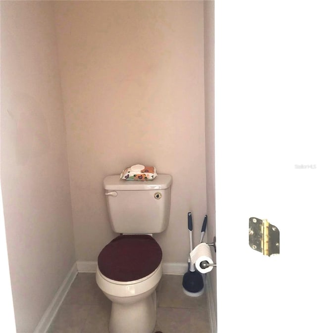 bathroom with toilet and tile patterned floors