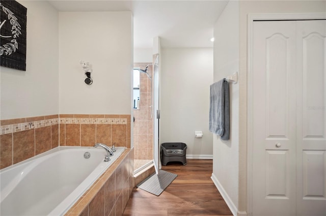 bathroom with hardwood / wood-style floors and plus walk in shower