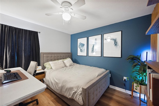 bedroom with dark hardwood / wood-style flooring and ceiling fan