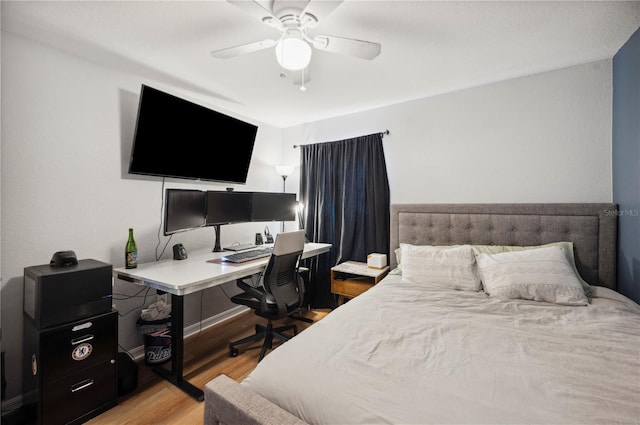 bedroom with light hardwood / wood-style flooring and ceiling fan