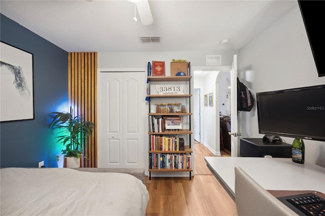 bedroom featuring a closet, hardwood / wood-style flooring, and ceiling fan