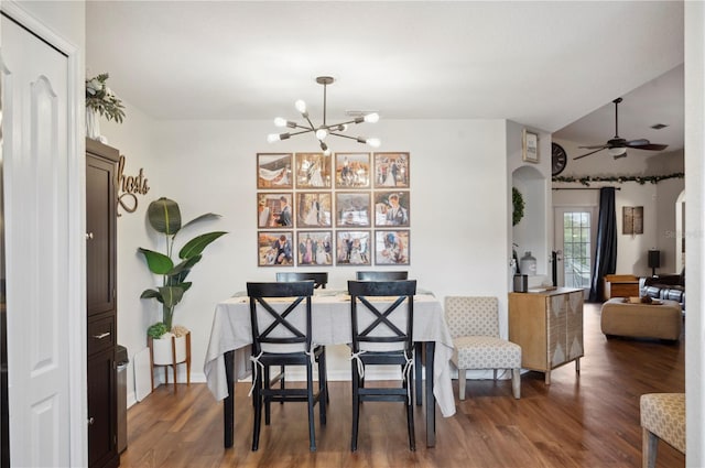 dining room featuring dark wood-type flooring and ceiling fan with notable chandelier