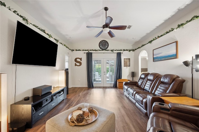 living room with dark wood-type flooring, ceiling fan, french doors, and lofted ceiling