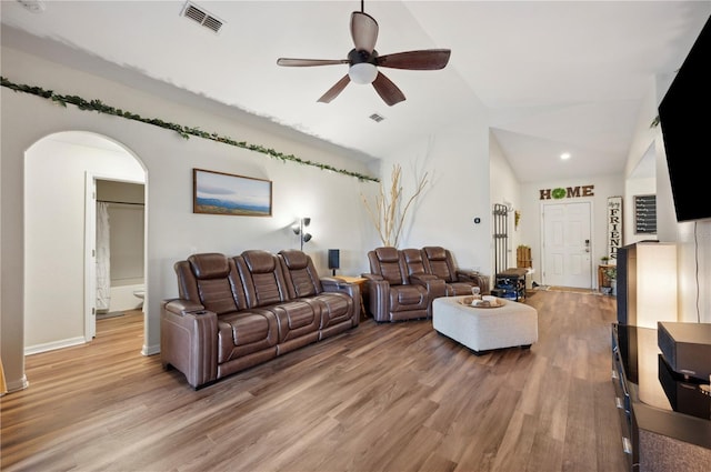 living room with light wood-type flooring, lofted ceiling, and ceiling fan