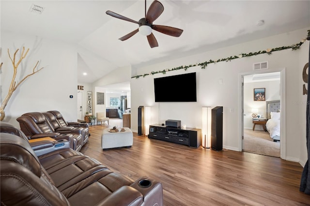 living room featuring hardwood / wood-style flooring, ceiling fan, and vaulted ceiling