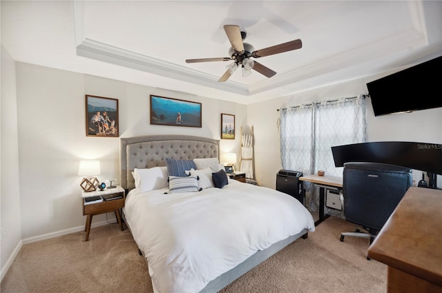 bedroom featuring light carpet, ceiling fan, crown molding, and a tray ceiling