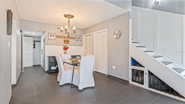 tiled dining area with an inviting chandelier