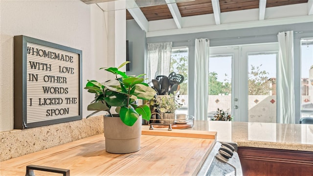 interior details with wood ceiling, french doors, and beam ceiling