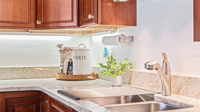 kitchen featuring sink and light stone counters