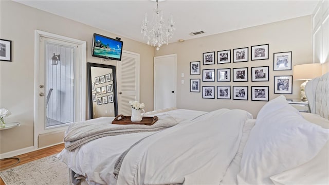 bedroom featuring hardwood / wood-style floors and a notable chandelier