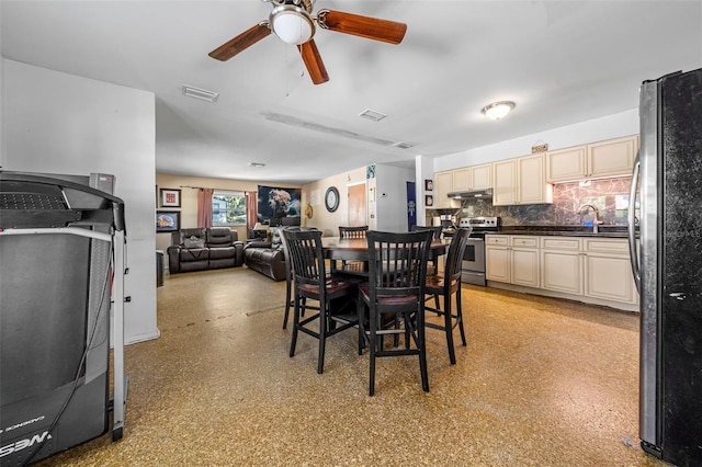 dining room featuring sink and ceiling fan