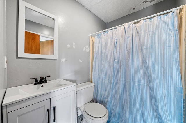 bathroom with toilet, vanity, a textured ceiling, and curtained shower