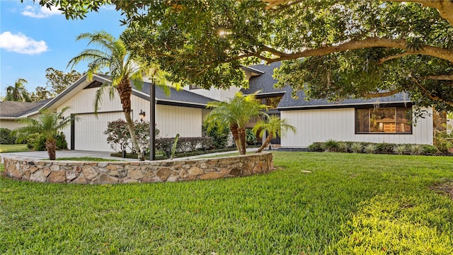 view of front of house with a garage and a front lawn