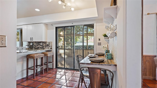 dining room with wood walls