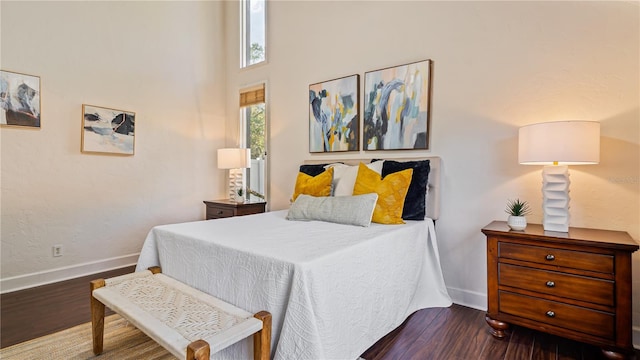 bedroom with dark wood-type flooring