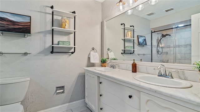 bathroom with vanity, toilet, and a shower with shower door