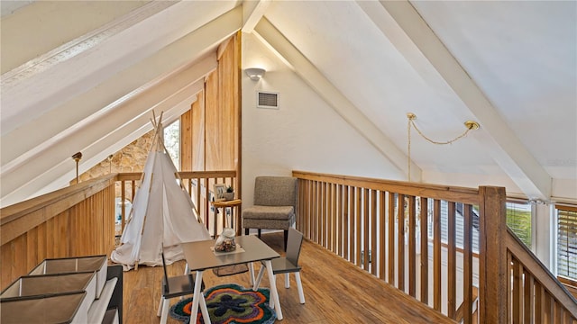 interior space featuring hardwood / wood-style flooring and lofted ceiling with beams