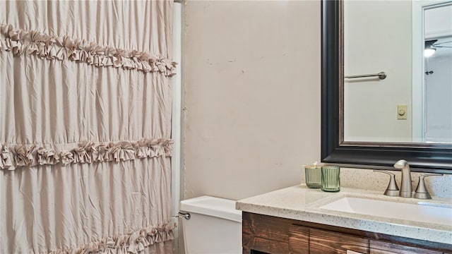 bathroom featuring vanity and toilet