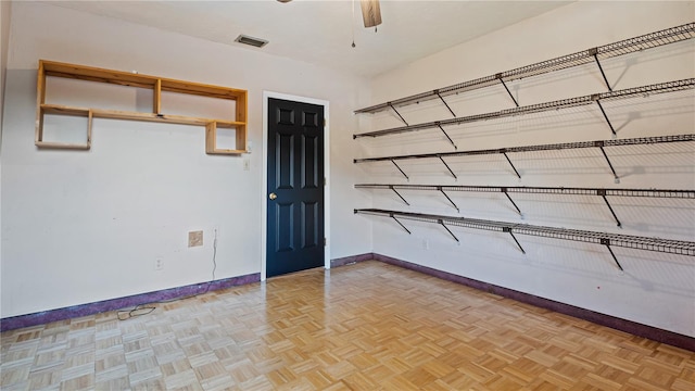 unfurnished room featuring ceiling fan and light parquet floors