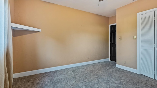 unfurnished bedroom featuring carpet and a closet