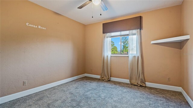 spare room featuring ceiling fan and carpet