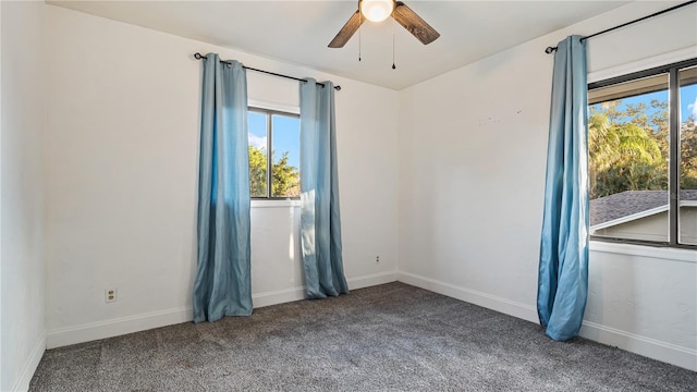 carpeted spare room with ceiling fan