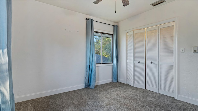 unfurnished bedroom with ceiling fan, carpet floors, and a closet