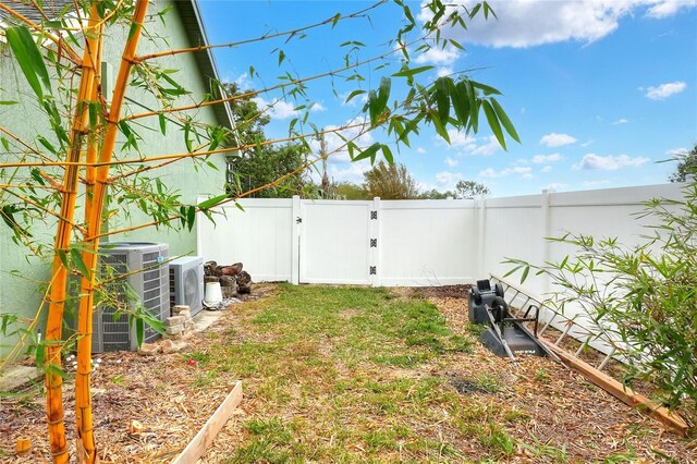 1935 Austin Ter, Winter Haven, FL 33884 - view of yard featuring a gate, a fenced backyard, and central AC unit