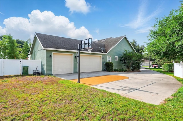 1935 Austin Ter, Winter Haven, FL 33884 - view of side of home featuring an attached garage, fence, and a lawn