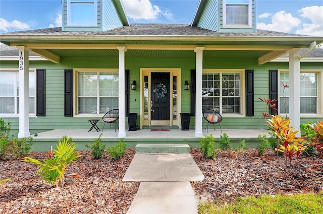 1935 Austin Ter, Winter Haven, FL 33884 - doorway to property featuring a porch and a shingled roof