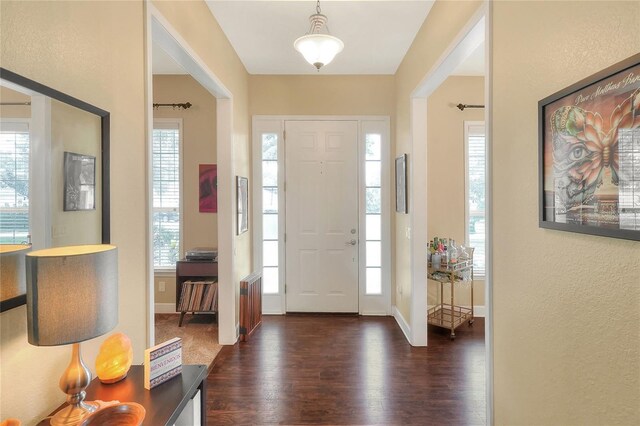 1935 Austin Ter, Winter Haven, FL 33884 - foyer featuring baseboards, dark wood finished floors, and a textured wall