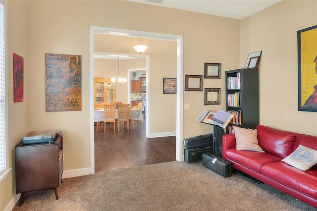 1935 Austin Ter, Winter Haven, FL 33884 - living area featuring an inviting chandelier, baseboards, and carpet floors