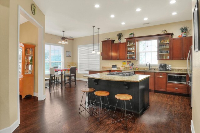 1935 Austin Ter, Winter Haven, FL 33884 - kitchen featuring a wealth of natural light, light stone counters, dark wood finished floors, and appliances with stainless steel finishes