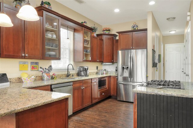 1935 Austin Ter, Winter Haven, FL 33884 - kitchen with glass insert cabinets, light stone counters, a sink, dark wood-type flooring, and appliances with stainless steel finishes