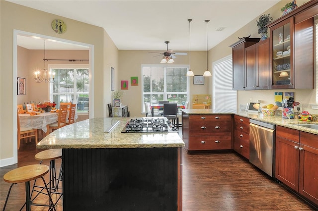 1935 Austin Ter, Winter Haven, FL 33884 - kitchen featuring plenty of natural light, glass insert cabinets, a breakfast bar, dark wood-style flooring, and appliances with stainless steel finishes