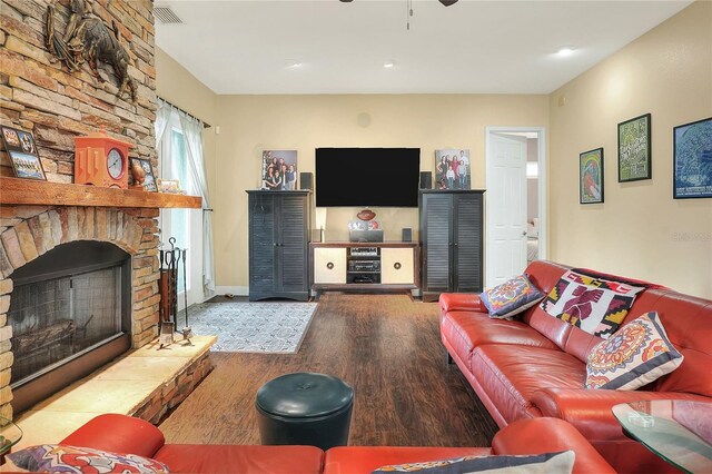1935 Austin Ter, Winter Haven, FL 33884 - living room featuring baseboards, visible vents, ceiling fan, wood finished floors, and a large fireplace