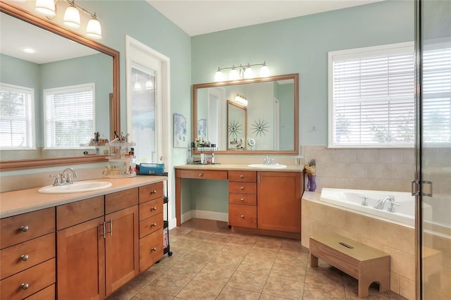 1935 Austin Ter, Winter Haven, FL 33884 - bathroom with a bath, tile patterned flooring, two vanities, and a sink
