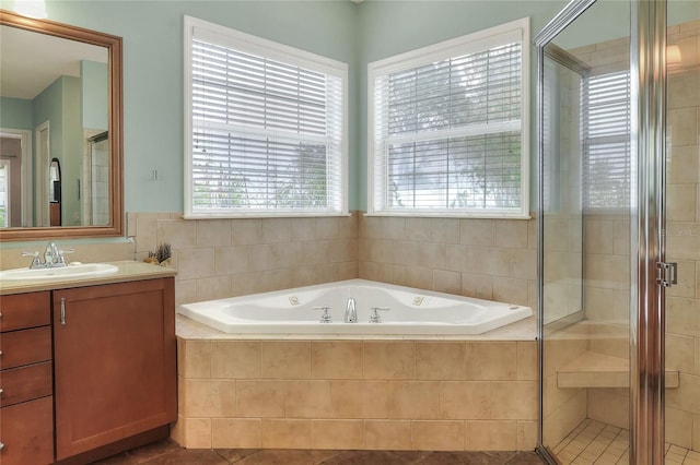1935 Austin Ter, Winter Haven, FL 33884 - bathroom with a stall shower, vanity, a garden tub, and tile patterned floors