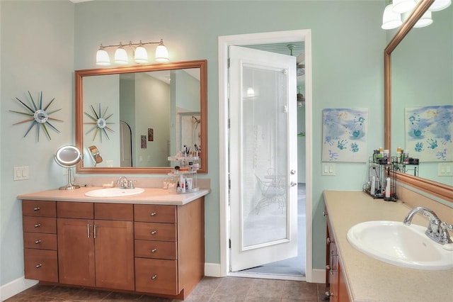1935 Austin Ter, Winter Haven, FL 33884 - bathroom featuring baseboards, tile patterned flooring, two vanities, and a sink