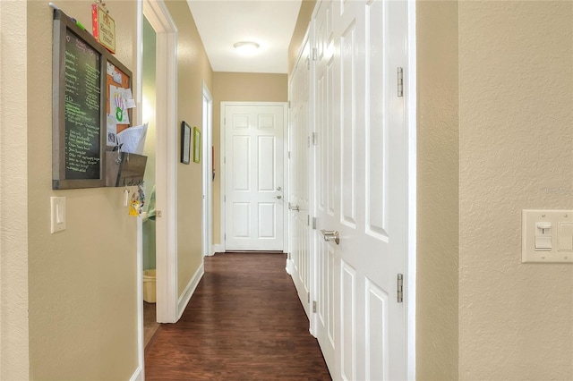 1935 Austin Ter, Winter Haven, FL 33884 - hall featuring a textured wall, baseboards, and dark wood-type flooring