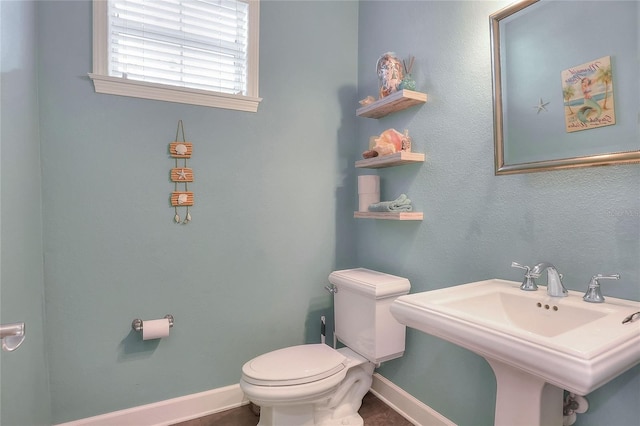 1935 Austin Ter, Winter Haven, FL 33884 - bathroom with toilet, baseboards, and a sink