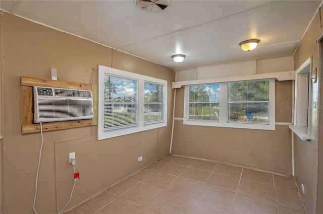 unfurnished sunroom with an AC wall unit