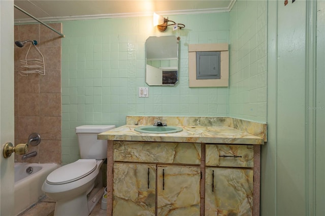 full bathroom with vanity, ornamental molding, toilet, and tiled shower / bath